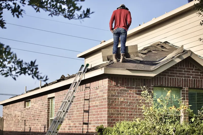 Professional roofer working on a residential roof in Provincetown